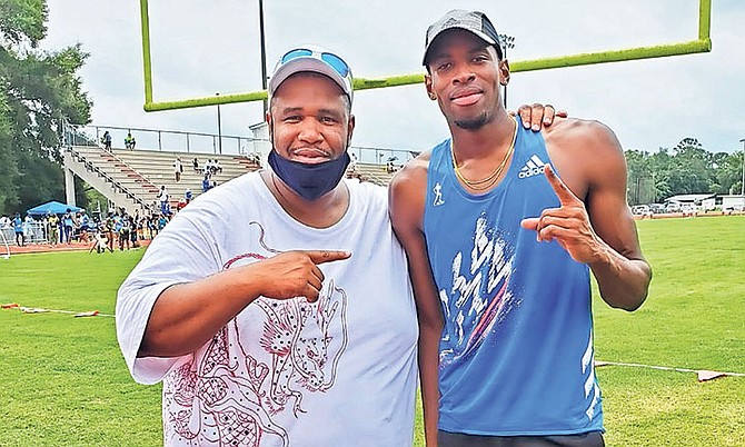 STEVEN GARDINER, right, is congratulated by meet director Daniel Medley.