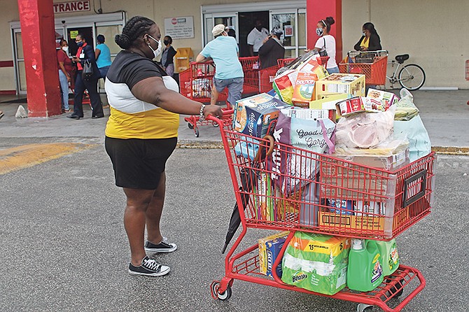 Grand Bahamians stock up on supplies before the island's lockdown. Photo: Vandyke Hepburn