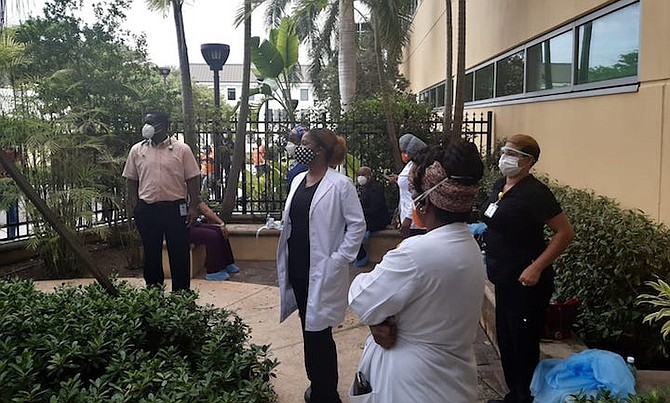 Doctors and nurses outside PMH on Tuesday.