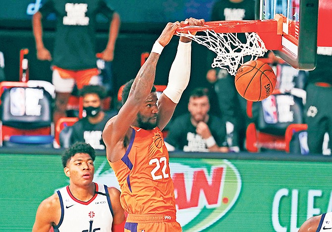 Phoenix Suns centre Deandre Ayton (22) dunks the ball as Washington Wizards forward Rui Hachimura looks on during the second half of an NBA basketball game Friday, July 31. (Kim Klement/Pool Photo via AP)