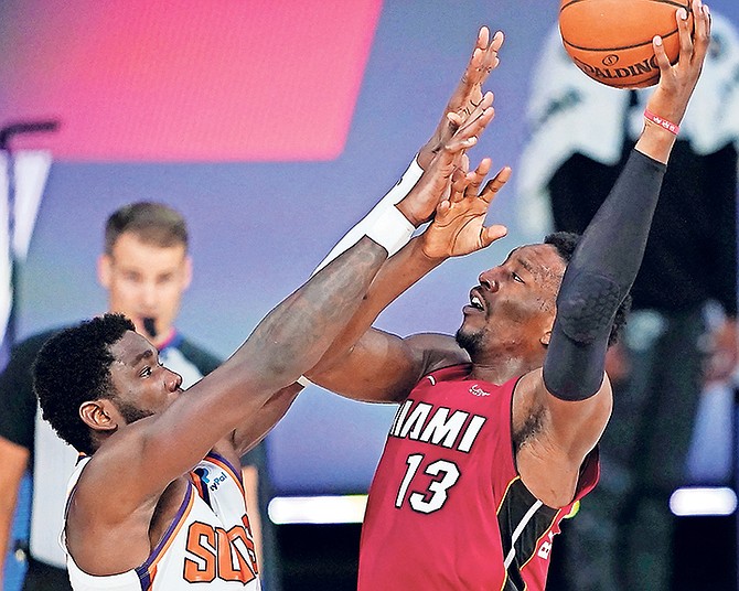 Heat’s Bam Adebayo (13) is fouled by Suns’ Deandre Ayton during the second half on Saturday night in Lake Buena Vista, Florida.

(AP Photo/Ashley Landis)