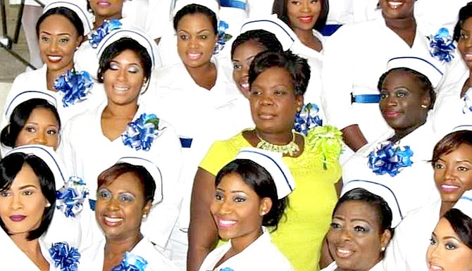 THERESA, centre right, proudly flanked by a group of nursing graduates.