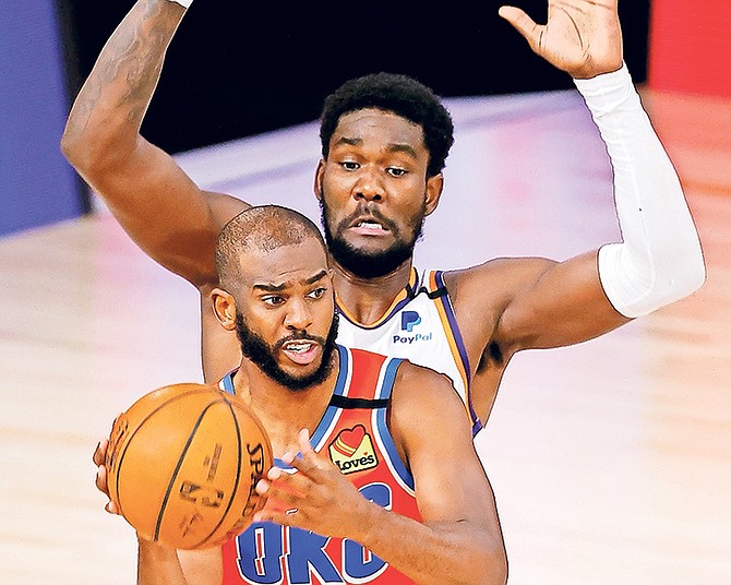 Oklahoma City Thunder’s Chris Paul (3) is pressured by Phoenix Suns’ Deandre Ayton during the third quarter in Lake Buena Vista, Florida.

(Mike Ehrmann/Pool Photo via AP)