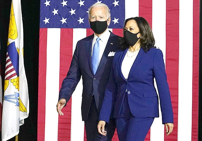 Democratic presidential candidate Joe Biden and his running mate Kamala Harris arrive to speak at a news conference at Alexis Dupont High School in Wilmington, Delaware.