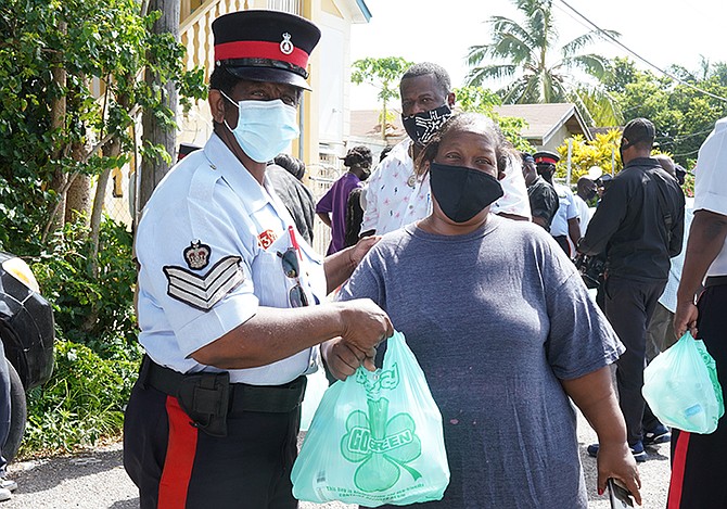 Police officers handing out water and masks in New Providence last weekend.