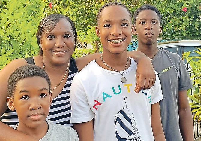 Birthday girl Varel Davis celebrates her 44th birthday with her two sons - Davon and Deon - and nephew Dexter Clarke.