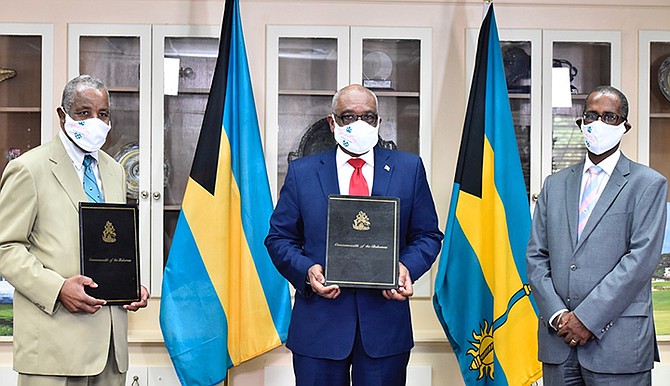 The Jack's Bay Heads of Agreement signing took place Friday morning at Cabinet Office. Pictured are Prime Minister Dr Hubert Minnis, centre, with Developers Franklyn Wilson, left, and O.A. T. 'Tommy' Turnquest. (BIS Photo/Kemuel Stubbs)