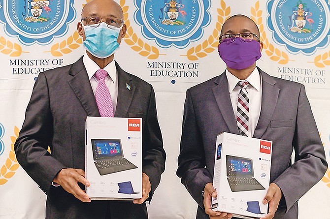MINISTER of Education Jeff Lloyd, left, with one of the devices paid for thanks to Leno’s donation.
Photo: Donovan McIntosh