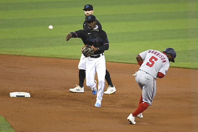 Miami Marlins shortstop Jazz Chisholm throws to first base for a double play after tagging out Josh Harrison during the first inning of a second game of doubleheader against the Washington Nationals, Sunday, Sept. 20, 2020, in Miami. (AP Photo/Gaston De Cardenas)