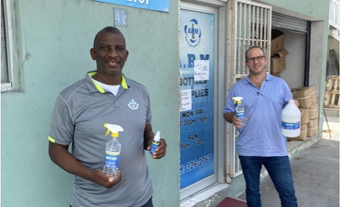 ANDREW MCFALL, owner of ARM Bottles (left) and Phillip Whitehead at the ARM Bottling Plant on
Crooked Island St.