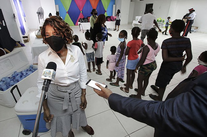 PATRICIA Minnis greets children of Free Town at their party at Pilgrim Baptist Temple Community
Centre, St James Road on Friday. Photo: Derek Smith/BIS