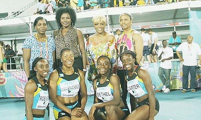 Golden Girls Savatheda Fynes, Pauline Davis Thompson, Eldece Clarke and Chandra Sturrup pose behind V'Alonee Robinson, Debbie Ferguson McKenzie, Breanne Bethel and Tayla Carter at the IAAF World Relays in Nassau.