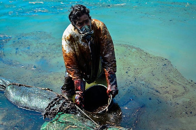 A MAN scoops leaked oil from the vessel MV Wakashio, belonging to a Japanese company that ran aground near Blue Bay Marine Park off the coast of south-east Mauritius on August 2, 2020. “As soon as you go south of Mauritius, you start smelling the oil. Within a short time you have a headache and, if you are near the coast, you quickly become ill…”