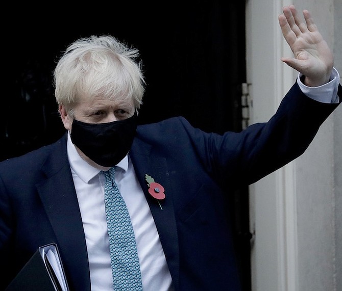 BRITISH Prime Minister Boris Johnson waving outside 10 Downing Street in England - but with new
lockdowns on the way, is he also waving goodbye to prospects of an economic recovery?