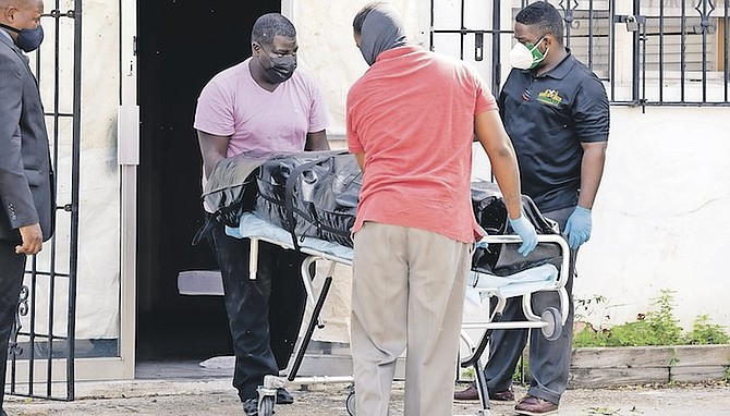 A BODY is removed from a building on Mackey Street yesterday. It is understood the deceased man was Geoffrey Martin. Photo: Donovan McIntosh