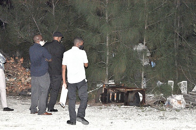 INVESTIGATORS at the scene in Queen’s Cove after a body was found. Photo: Vandyke Hepburn