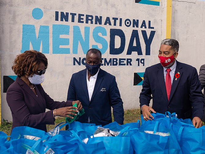 PATRICIA MINNIS, the wife of Prime Minister Dr Hubert Minnis, with Keith Cos, president of the International Men’s Day organisation, centre, and Frankie Campbell MP. Photos: Donovan McIntosh