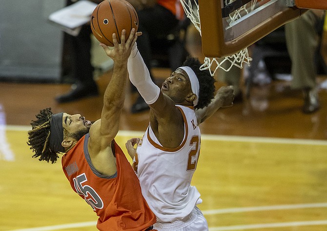 Texas forward Kai Jones, right, blocks Texas-Rio Grande Valley's Uche Dibiamaka during the second half of an NCAA college basketball game Wednesday Nov. 25, 2020, in Austin, Texas. (Ricardo B. Brazziell/Austin American-Statesman via AP)