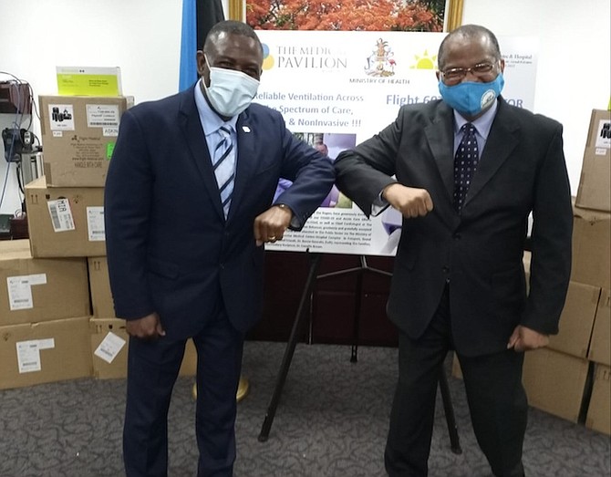 MINISTER of Health Renward Wells (left), and Dr Conville Brown, founder and physician-in-chief,
as well as chief cardiologist at Bahamas Heart Centre and the Medical Pavilion Bahamas, who
facilitated the donations. Photo: Ulric Woodside/BIS