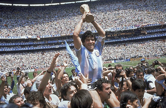 Diego Maradona holds up his team's trophy after Argentina's 3-2 victory over West Germany at the World Cup final in the Azteca Stadium in Mexico City in 1986. (AP Photo/Carlo Fumagalli, File)