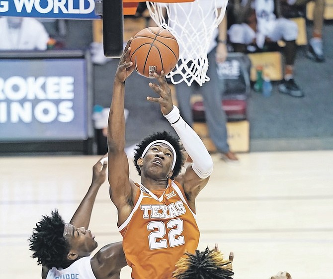 TEXAS forward Kai Jones (22), of The Bahamas, grabs a rebound over North Carolina forward Day’Ron Sharpe (11) in the first half of their NCAA college basketball game for the championship of the Maui Invitational yesterday in Asheville, N.C. 
(AP Photo/Kathy Kmonicek)