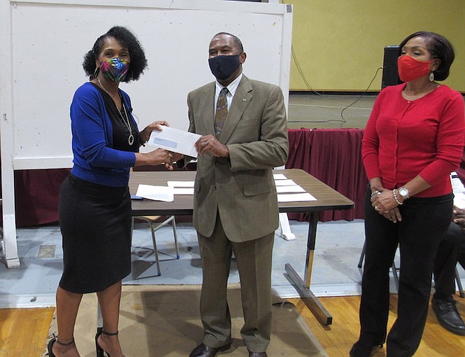 MARGO VICTOR, left, manager of San Jose Construction (Bahamas) Ltd, handing out some of the gift certificates to help students in Grand Bahama and Bimini.