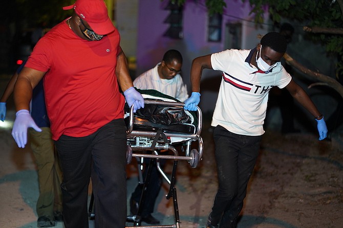 The body is removed from the scene on Wednesday night. Photo: Terrel W Carey/Tribune staff