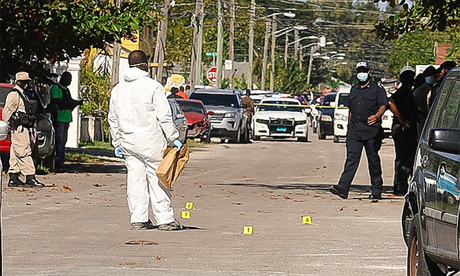 INVESTIGATORS on the scene of Wednesday's police-involved shooting that left one man dead.
Photo: Donovan McIntosh/Tribune Staff