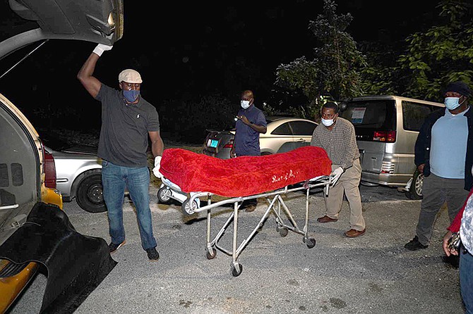 The victim's body is removed from the scene on Gilbert Street early on Monday. Photo: Terrel W Carey Sr/Tribune staff
