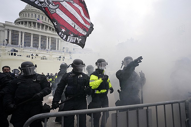 Police hold off Trump supporters who tried to break through a police barrier, Wednesday, at the Capitol in Washington. (AP Photo/Julio Cortez)