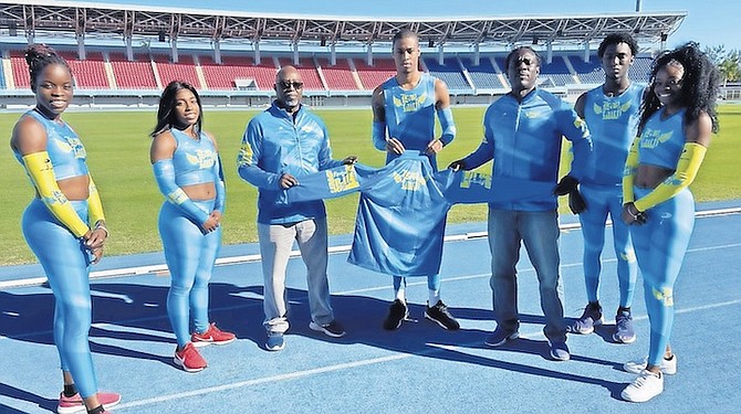 DELVIN Moss presents uniforms to coach James Rolle and jumpers Tamara Myers, Andira Ferguson, Stoney Duncanson, Stephan Farquharson and Daejha Moss.