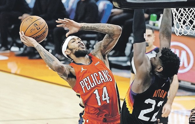 NEW Orleans Pelicans forward Brandon Ingram shoots over Phoenix Suns centre Deandre Ayton.