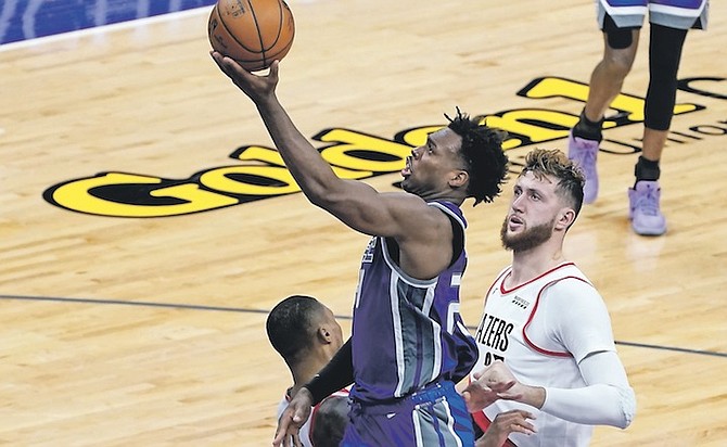 SACRAMENTO Kings guard Buddy Hield goes to the basket past Portland Trail Blazers centre Jusuf Nurkic, right, during the second half last night. The Trail Blazers won 132-126. Hield also posted five assists, six rebounds and a steal in 38 minutes. He shot 8-18 from three-point range. 
(AP Photo/Rich Pedroncelli)