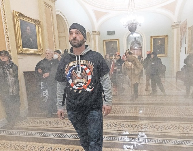 SMOKE fills the walkway outside the Senate Chamber as supporters of President Donald Trump are confronted by US Capitol Police officers inside the Capitol on January 6.
Photo: Manuel Balce Ceneta/AP