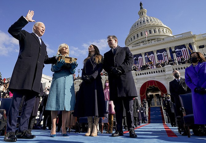 Joe Biden is sworn in as the 46th president of the United States by Chief Justice John Roberts as Jill Biden holds the Bible during the 59th Presidential Inauguration at the U.S. Capitol in Washington, Wednesday – their children Ashley and Hunter watch. Vice President Kamala Harris is pictured right. (AP Photo/Andrew Harnik, Pool)