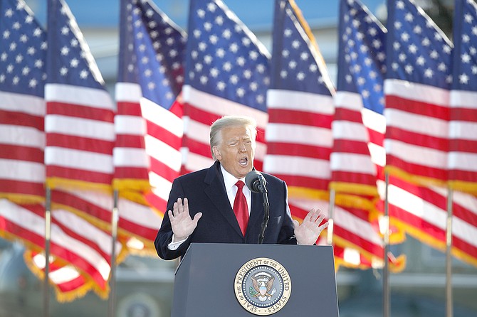 ON his last day as president, Donald Trump speaks to the crowd before boarding Air Force One at Andrews Air Force Base, Md., Wednesday.
(AP Photo/Luis M. Alvarez)