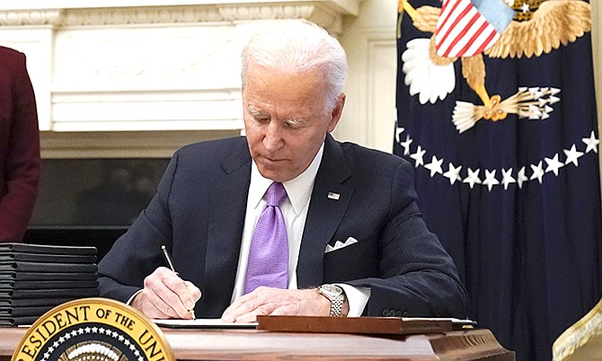 PRESIDENT Joe Biden signing executive orders in the Oval Office of the White House. Among his first actions was to introduce a quarantine for people arriving in the US.
Photo: Evan Vucci/AP