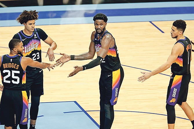 SEASON HIGH DOUBLE DOUBLE: Suns centre Deandre Ayton, far right, is congratulated by Mikal Bridges (25), Cameron Johnson (23) and Devin Booker (1), not in picture, after hitting a free throw during the second half against the Houston Rockets on Wednesday night in Houston.
 (AP Photo/Michael Wyke)