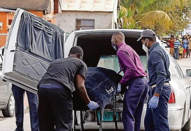 A body is taken from the scene of Monday's murder.
Photo: Donovan McIntosh/Tribune Staff