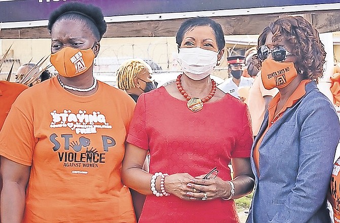 A CAUSE for all to support - Patricia Minnis and Ann Marie Davis, the wives of party leaders Dr Hubert Minnis and Philip Davis, along with Kim Moultrie, left, wife of the House Speaker, at a Zonta event in November calling for an end to violence against women.