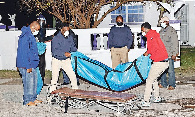 A body is removed from the scene of a murder last night after an argument following a car accident at the junction of Fifth Street and Palm Tree Avenue led to a man being stabbed to death. Photo: Donovan McIntosh/Tribune Staff