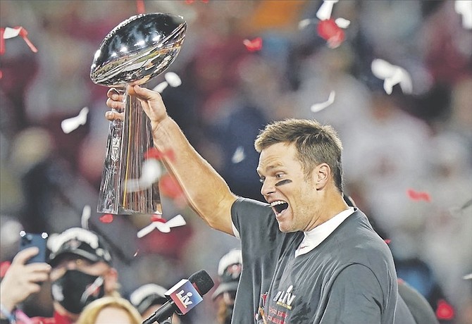G.O.A.T.: Tampa Bay Buccaneers quarterback Tom Brady celebrates with the Vince Lombardi Trophy after the NFL Super Bowl 55 football game against the Kansas City Chiefs last night in Tampa, Florida. The Buccaneers defeated the Chiefs 31-9 to win the Super Bowl.               (AP Photo/Lynne Sladky)