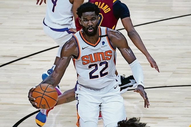 Phoenix Suns centre Deandre Ayton (22) looks to pass against the Cleveland Cavaliers during the second half last night in Phoenix. (AP Photo/Matt York)
