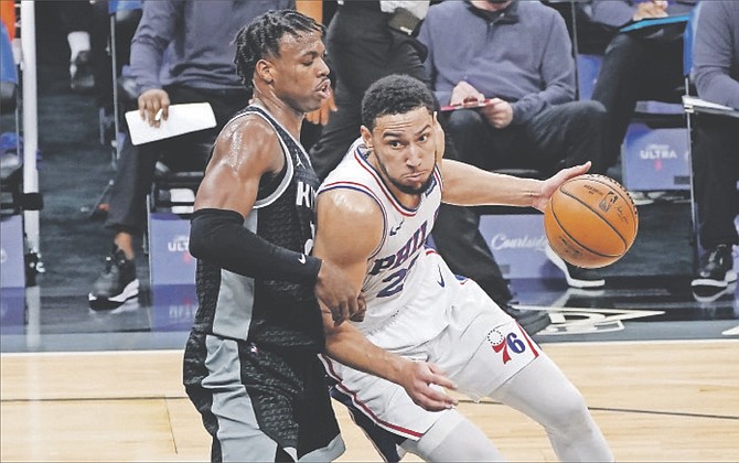 76ers guard Ben Simmons, right, drives against Sacramento Kings guard Buddy Hield, left, during the first half last night in Sacramento, California. 
                                                                                                                                                                                                         (AP Photo/Rich Pedroncelli)