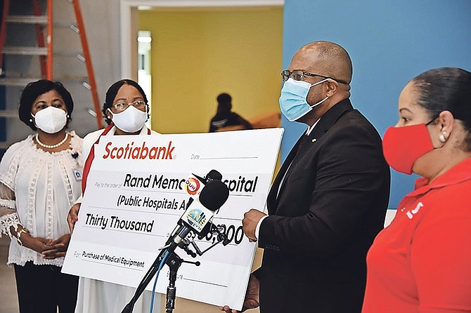 Scotiabank managing director Roger Archer presents a $30,000 cheque donation on Friday to the Rand Memorial Hospital in Grand Bahama. Mr Archer was also given a tour of the Paediatric Unit, which is under renovation. Photo: Preston Knowles Photography.