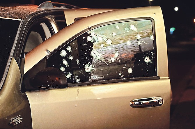 Bullet holes in the car window.