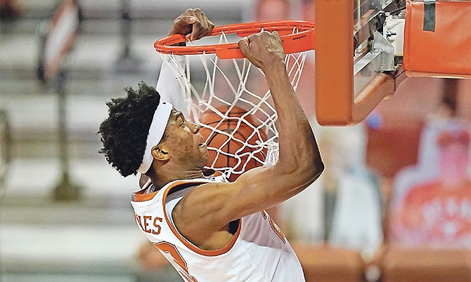 Texas forward Kai Jones dunks the ball during the first half of an NCAA college basketball game against Kansas Tuesday night in Austin, Texas. (AP Photo/Eric Gay)