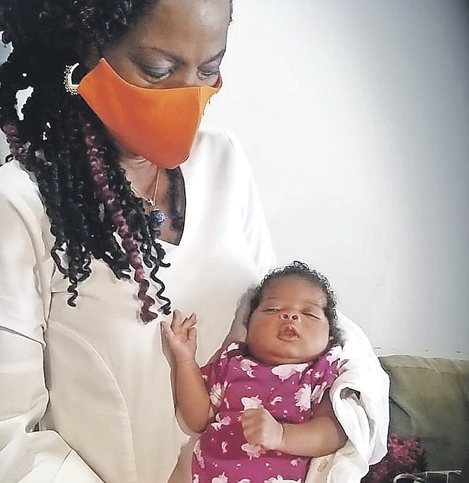 FOX Hill MP Shonel Ferguson with the baby of Alysha - who was left to sleep on the floor after COVID-19 cost her the Baha Mar job she worked at and left her with empty cupboards.