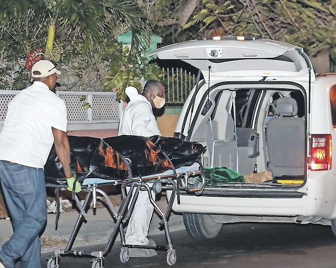 A BODY is taken from the scene after last night’s shooting. Photo: Donovan McIntosh/Tribune Staff