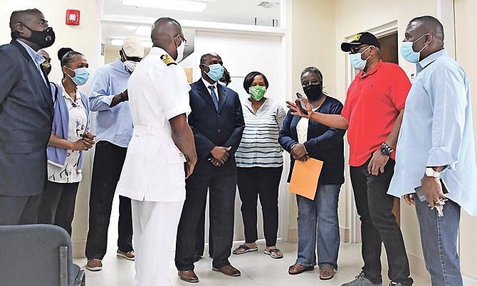 PRIME Minister Dr Hubert Minnis and Health Minister Renward Wells during a visit to the COVID
vaccine storage facility on Saturday. Photo: Yontalay Bowe